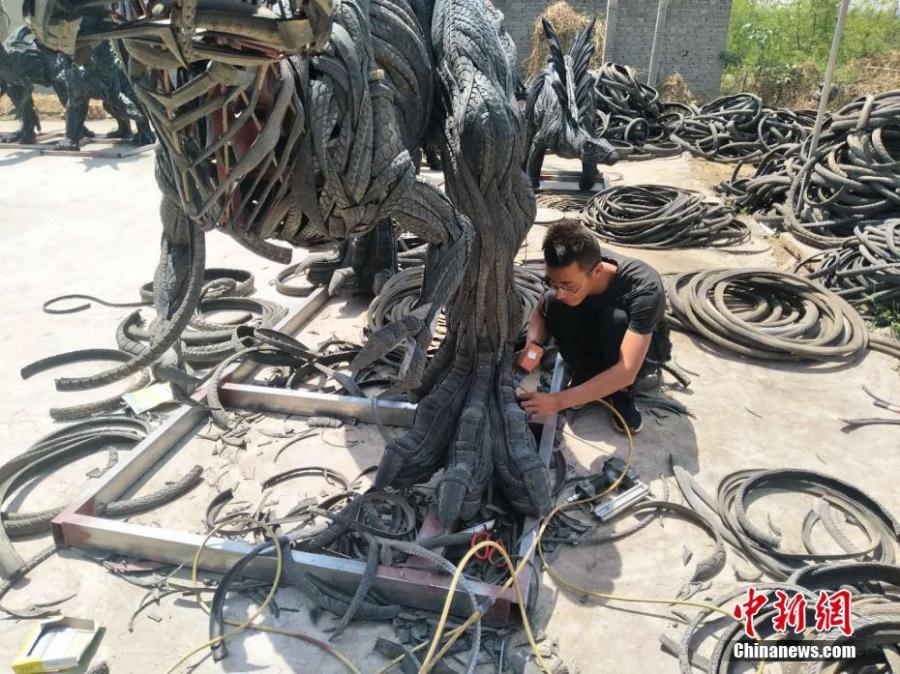 Cao Shengge shows his homemade sculptures made out of used tyres in Xingtai City, Hebei province. Cao became interested in making sculptures with tyres in 2015. He has recycled nearly 50 tons of otherwise waste tyres to create about 100 works, including mythical figures, beasts, and the twelve zodiac animals. He said the tyres usually needed to be cut into pieces and then put together to form a creation, a process that may take tens of days. Cao also said he hopes to organize an exhibition of his works and promote public awareness of environmental protection. (Photo provided to China News Service)