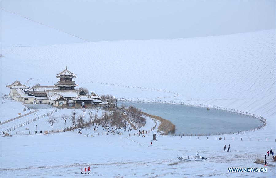 Photo taken on Dec. 2, 2018 shows the snow scenery of the Mingsha Mountain and Crescent Spring scenic area in Dunhuang, northwest China\'s Gansu Province. China will hold the Conference on Dialogue of Asian Civilizations starting from May 15. Under the theme of \