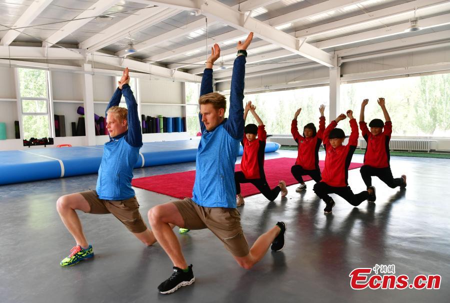 Coaches from Finland instruct students at the Youth Winter Olympic Sports School, or Xuanhua No. 2 Middle School, in Zhangjiakou, Hebei Province, May 9, 2019. The school established in 2015 is the only of its kind to specialize on training of Winter Olympic sports in China. The school has recruited more than 1,200 students, including 200 trained to be competitive skiers. Located some 200km northwest of Beijing, Zhangjiakou will host snowboarding, freestyle skiing, cross-country skiing, ski jumping, Nordic combined and biathlon competitions during the 2022 Winter Games. (Photo: China News Service/Zhai Yujia)