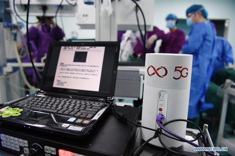 Medical staff of the Shitai County People\'s Hospital conduct an endoscopic surgery under the guidance from experts of the Second Hospital of Anhui Medical University (AMU) through a 5G-supported remote collaborative operating platform in Shitai, east China\'s Anhui Province, May 10, 2019. The first 5G network-supported remote collaborative operation was successfully conducted Friday at two hospitals in Anhui. Medical experts from the Second Hospital of AMU guided two endoscopic surgeries operated by another county hospital via 5G technology remotely and timely, during which the experts remote-adjusted the operating machines through voice. (Xinhua/Xu Minhao)
