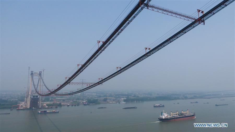 Aerial photo shows the construction site of the Wufengshan Yangtze River Bridge in Zhenjiang, east China\'s Jiangsu Province, May 10, 2019. Some 704 main cable strands for the bridge, a part of the Lianyungang-Zhenjiang railway, were successfully erected Friday in Jiangsu, marking the erection of China\'s first road-rail suspension bridge\'s main cable was finished. The bridge is scheduled to be completed within 2019 and open to traffic by 2020. (Xinhua/Li Xiang)