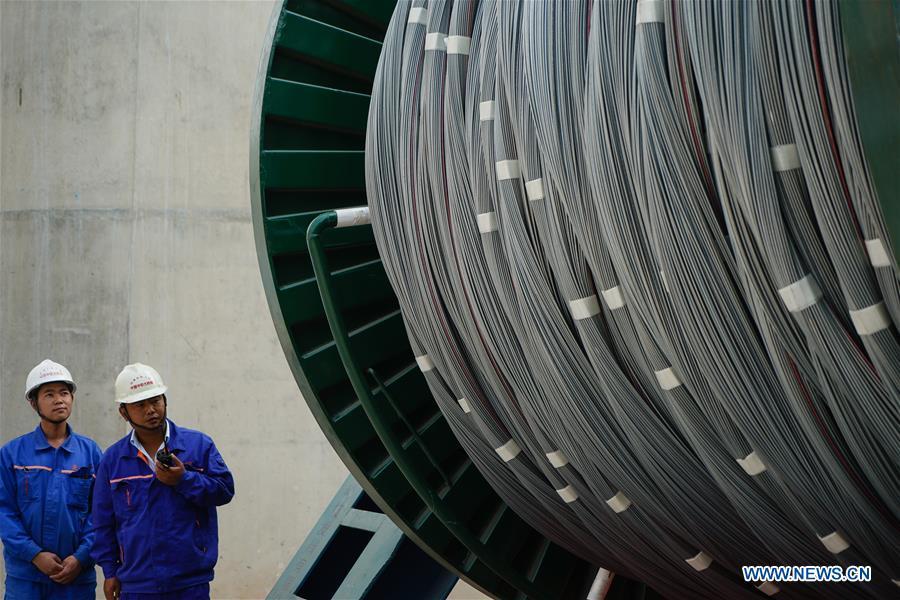 Workers are seen at the construction site of the Wufengshan Yangtze River Bridge in Zhenjiang, east China\'s Jiangsu Province, May 10, 2019. Some 704 main cable strands for the bridge, a part of the Lianyungang-Zhenjiang railway, were successfully erected Friday in Jiangsu, marking the erection of China\'s first road-rail suspension bridge\'s main cable was finished. The bridge is scheduled to be completed within 2019 and open to traffic by 2020. (Xinhua/Li Xiang)