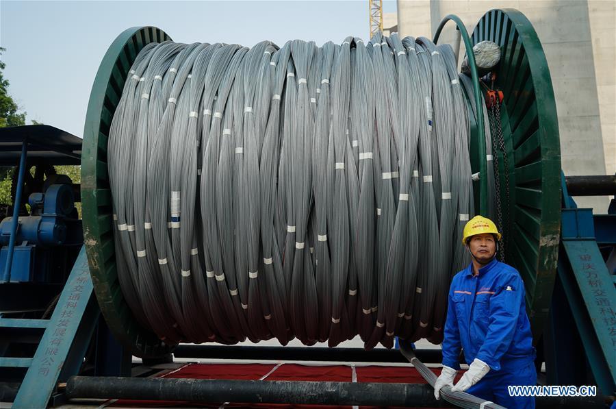 A worker is seen at the construction site of the Wufengshan Yangtze River Bridge in Zhenjiang, east China\'s Jiangsu Province, May 10, 2019. Some 704 main cable strands for the bridge, a part of the Lianyungang-Zhenjiang railway, were successfully erected Friday in Jiangsu, marking the erection of China\'s first road-rail suspension bridge\'s main cable was finished. The bridge is scheduled to be completed within 2019 and open to traffic by 2020. (Xinhua/Li Xiang)