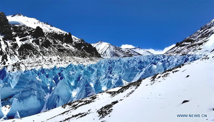 Seracs are seen at the foot of Mount Qomolangma in southwest China\'s Tibet Autonomous Region, April 19, 2019. Every year, for a few weeks, hundreds of climbers and supporting personnel come to the base camp of the northern face of Mount Qomolangma, trying to reach the summit of the tallest and most famous mountain in the world. Before starting climbing, they need to hike several times between elevations from 5,000 meters to 7,000 meters, giving their bodies some time to adapt. When this process is over, it\'s all up to the weather. The base camp is a popular place to wait for the window. Among the six camps on the northern face, the base camp at an altitude of 5,200 meters is the furthest cars can reach and therefor the most equipped. Besides food and accommodation, climbers can also enjoy tea and massage. They can also play football on perhaps the highest field. There\'s even a simple gym in the camp. Environmental protection is a priority here. Garbage sacks are given to each climbing team. Special containers are put in every camp to collect trash and sewage. The collected trash must be treated 100 kilometers away, and the only road is a zigzagging track. It is not trucks, but yaks that are generally used to make the journey. Actually yaks are vital on the mountain. Beyond the base camp, yak is the only reliable transport. (Xinhua/Zhaxi Tsering)