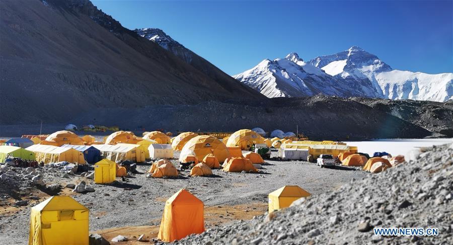 Photo taken on April 29, 2019 shows the base camp of the northern face of Mount Qomolangma in southwest China\'s Tibet Autonomous Region. Every year, for a few weeks, hundreds of climbers and supporting personnel come to the base camp of the northern face of Mount Qomolangma, trying to reach the summit of the tallest and most famous mountain in the world. Before starting climbing, they need to hike several times between elevations from 5,000 meters to 7,000 meters, giving their bodies some time to adapt. When this process is over, it\'s all up to the weather. The base camp is a popular place to wait for the window. Among the six camps on the northern face, the base camp at an altitude of 5,200 meters is the furthest cars can reach and therefor the most equipped. Besides food and accommodation, climbers can also enjoy tea and massage. They can also play football on perhaps the highest field. There\'s even a simple gym in the camp. Environmental protection is a priority here. Garbage sacks are given to each climbing team. Special containers are put in every camp to collect trash and sewage. The collected trash must be treated 100 kilometers away, and the only road is a zigzagging track. It is not trucks, but yaks that are generally used to make the journey. Actually yaks are vital on the mountain. Beyond the base camp, yak is the only reliable transport. (Xinhua/Zhaxi Tsering)