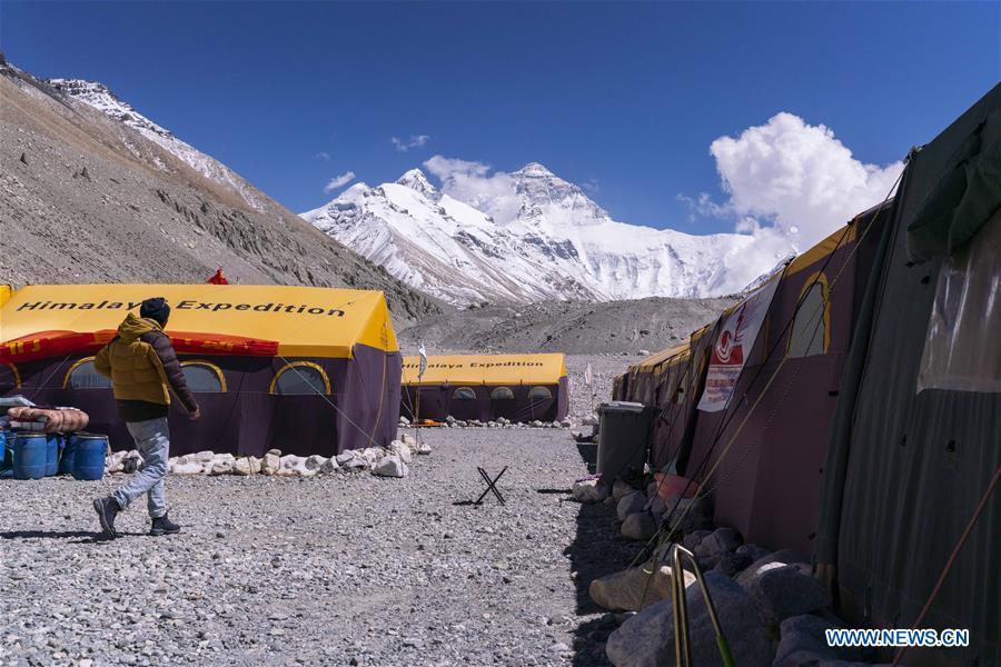 The Chinese mountaineering camp is seen at the base camp of the northern face of Mount Qomolangma in southwest China\'s Tibet Autonomous Region, April 26, 2019. Every year, for a few weeks, hundreds of climbers and supporting personnel come to the base camp of the northern face of Mount Qomolangma, trying to reach the summit of the tallest and most famous mountain in the world. Before starting climbing, they need to hike several times between elevations from 5,000 meters to 7,000 meters, giving their bodies some time to adapt. When this process is over, it\'s all up to the weather. The base camp is a popular place to wait for the window. Among the six camps on the northern face, the base camp at an altitude of 5,200 meters is the furthest cars can reach and therefor the most equipped. Besides food and accommodation, climbers can also enjoy tea and massage. They can also play football on perhaps the highest field. There\'s even a simple gym in the camp. Environmental protection is a priority here. Garbage sacks are given to each climbing team. Special containers are put in every camp to collect trash and sewage. The collected trash must be treated 100 kilometers away, and the only road is a zigzagging track. It is not trucks, but yaks that are generally used to make the journey. Actually yaks are vital on the mountain. Beyond the base camp, yak is the only reliable transport. (Xinhua/Sun Fei)