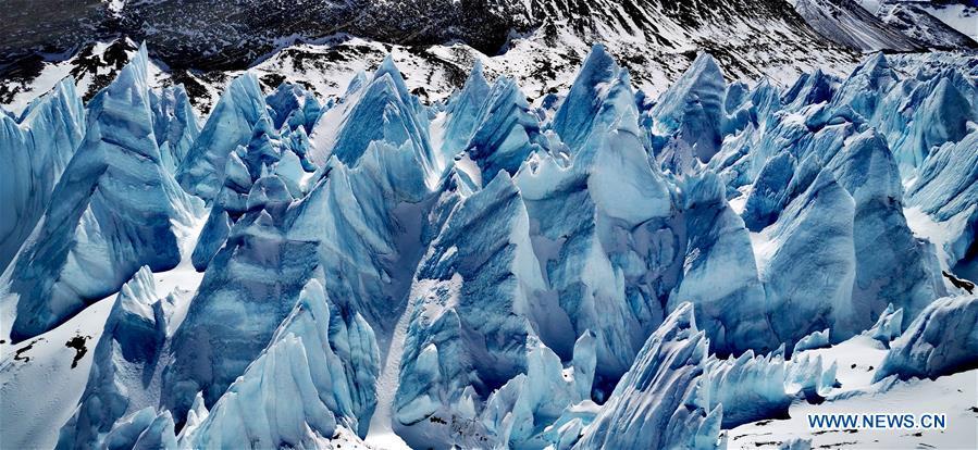 Seracs are seen at the foot of Mount Qomolangma in southwest China\'s Tibet Autonomous Region, April 19, 2019. Every year, for a few weeks, hundreds of climbers and supporting personnel come to the base camp of the northern face of Mount Qomolangma, trying to reach the summit of the tallest and most famous mountain in the world. Before starting climbing, they need to hike several times between elevations from 5,000 meters to 7,000 meters, giving their bodies some time to adapt. When this process is over, it\'s all up to the weather. The base camp is a popular place to wait for the window. Among the six camps on the northern face, the base camp at an altitude of 5,200 meters is the furthest cars can reach and therefor the most equipped. Besides food and accommodation, climbers can also enjoy tea and massage. They can also play football on perhaps the highest field. There\'s even a simple gym in the camp. Environmental protection is a priority here. Garbage sacks are given to each climbing team. Special containers are put in every camp to collect trash and sewage. The collected trash must be treated 100 kilometers away, and the only road is a zigzagging track. It is not trucks, but yaks that are generally used to make the journey. Actually yaks are vital on the mountain. Beyond the base camp, yak is the only reliable transport. (Xinhua/Zhaxi Tsering)