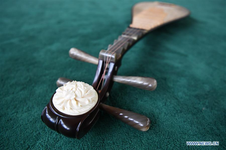 Pipa is pictured at Lanzhou traditional orchestra in Lanzhou, northwest China\'s Gansu Province, May 13, 2019. Pipa, a pear-shaped stringed instrument, is one of the traditional Chinese musical instruments. The pipa is played vertically and can be found in solos, ensembles or orchestras. The images of flying apsaras playing the pipa have been seen on murals in Gansu\'s Dunhuang Mogao Grottoes, a 1,600-year-old UNESCO world heritage site located at a cultural and religious crossroads area on the ancient Silk Road in Gansu. Nowadays contemporary dance performances inspired from those images on the murals have been staged times and times again. (Xinhua/Chen Bin)