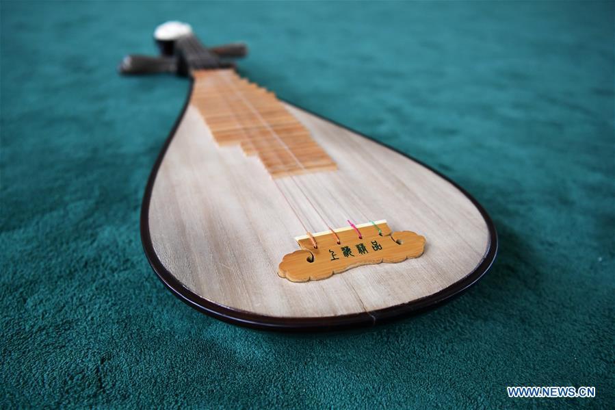 Pipa is pictured at Lanzhou traditional orchestra in Lanzhou, northwest China\'s Gansu Province, May 13, 2019. Pipa, a pear-shaped stringed instrument, is one of the traditional Chinese musical instruments. The pipa is played vertically and can be found in solos, ensembles or orchestras. The images of flying apsaras playing the pipa have been seen on murals in Gansu\'s Dunhuang Mogao Grottoes, a 1,600-year-old UNESCO world heritage site located at a cultural and religious crossroads area on the ancient Silk Road in Gansu. Nowadays contemporary dance performances inspired from those images on the murals have been staged times and times again. (Xinhua/Chen Bin)