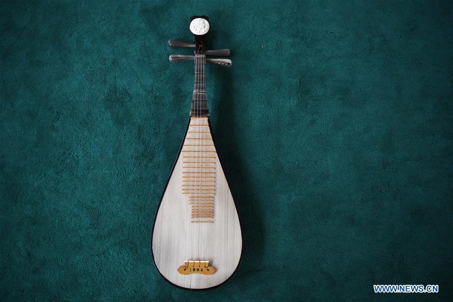 Pipa is pictured at Lanzhou traditional orchestra in Lanzhou, northwest China\'s Gansu Province, May 13, 2019. Pipa, a pear-shaped stringed instrument, is one of the traditional Chinese musical instruments. The pipa is played vertically and can be found in solos, ensembles or orchestras. The images of flying apsaras playing the pipa have been seen on murals in Gansu\'s Dunhuang Mogao Grottoes, a 1,600-year-old UNESCO world heritage site located at a cultural and religious crossroads area on the ancient Silk Road in Gansu. Nowadays contemporary dance performances inspired from those images on the murals have been staged times and times again. (Xinhua/Chen Bin)