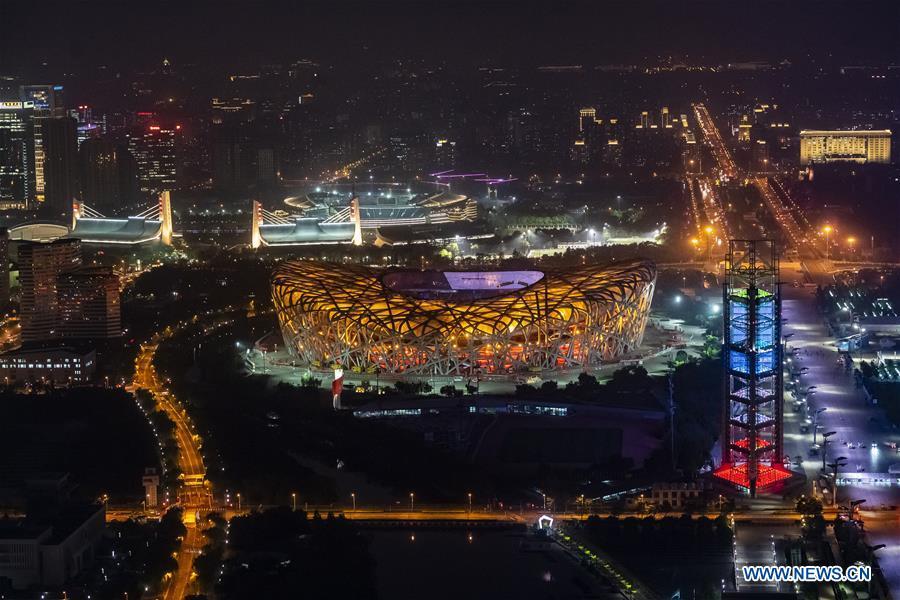 Photo taken on May 14, 2019 shows the night view of the National Stadium, also known as the Bird\'s Nest, in Beijing, capital of China. Roads and buildings were illuminated Tuesday evening before the upcoming Conference on Dialogue of Asian Civilizations (CDAC) in Beijing. (Xinhua/Shen Bohan)