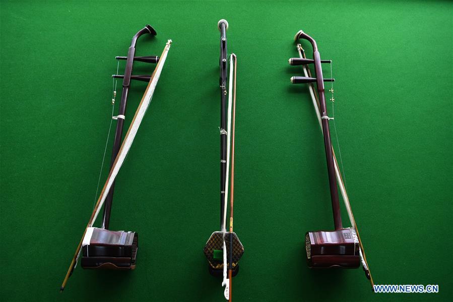 Erhu are pictured in Lanzhou, northwest China\'s Gansu Province, May 13, 2019. Erhu, sometimes known as the Chinese violin or Chinese two-stringed fiddle, is a Chinese traditional two-stringed bowed musical instrument. It is used as a solo instrument as well as in small ensembles and large orchestras. Erhu, traced back to ancient Chinese Tang dynasty (618-907), is now used in both traditional and contemporary music arrangements, such as in pop, rock and jazz. The famous solo pieces include Er Quan Ying Yue (Two Springs Reflecting the Moon) by Abing and Sai Ma (Horse Race) by Huang Haihuai. (Xinhua/Fan Peishen)