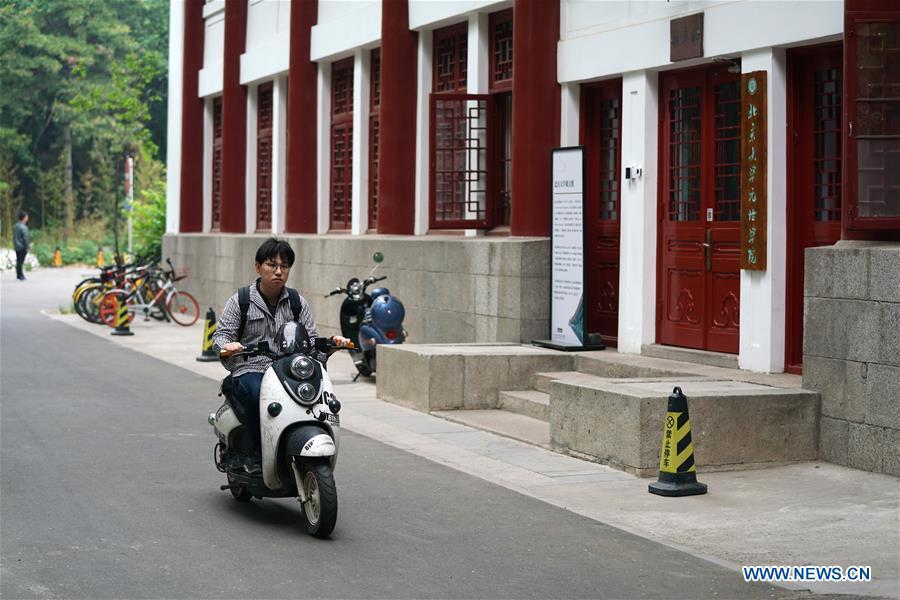 Ratjirot Aekkawat rides a scooter on the campus of the Peking University in Beijing, capital of China, May 12, 2019. Ratjirot Aekkawat is of mixed blood from China and Thailand. He came to study in China as a junior student and now he is a postgraduate student of the Peking University. He always talks about his experience in China with relatives and friends. He has witnessed the development of China in recent years, during which the environment and local governments\' working efficiencies have been greatly improved. Chinese and Thai cultures are influenced with each other. Many Thai people celebrate the Spring Festival every year and lots of Chinese go to Thailand for tourism. The photo of the historical site of Ayutthaya Dynasty taken by Ratjirot Aekkawat will be displayed in a photographic exhibition \