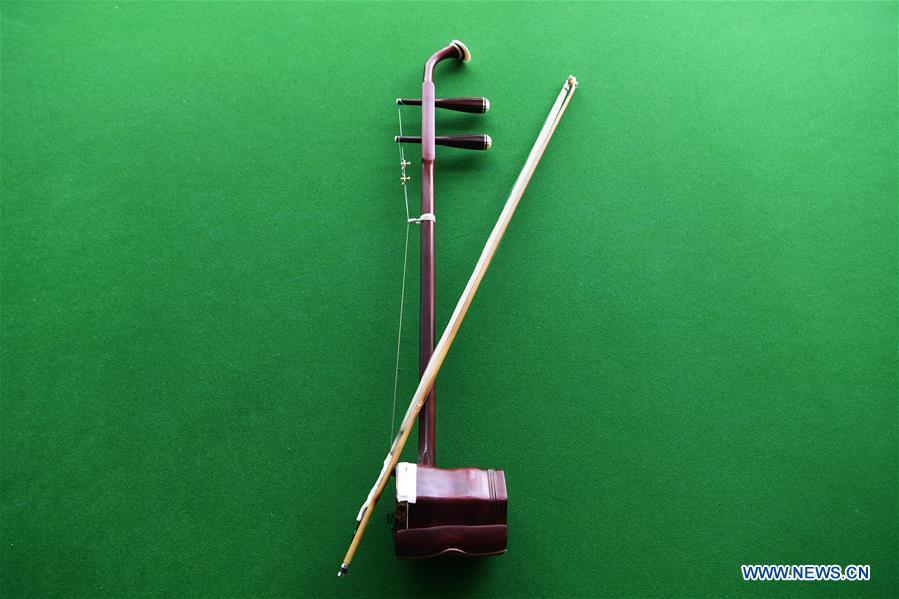 An Erhu is pictured in Lanzhou, northwest China\'s Gansu Province, May 13, 2019. Erhu, sometimes known as the Chinese violin or Chinese two-stringed fiddle, is a Chinese traditional two-stringed bowed musical instrument. It is used as a solo instrument as well as in small ensembles and large orchestras. Erhu, traced back to ancient Chinese Tang dynasty (618-907), is now used in both traditional and contemporary music arrangements, such as in pop, rock and jazz. The famous solo pieces include Er Quan Ying Yue (Two Springs Reflecting the Moon) by Abing and Sai Ma (Horse Race) by Huang Haihuai. (Xinhua/Fan Peishen)