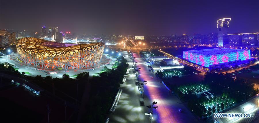 Photo taken on May 14, 2019 shows the night view of the National Stadium, also known as the Bird\'s Nest, and the National Swimming Center, also known as the Water Cube, in Beijing, capital of China. Roads and buildings were illuminated Tuesday evening before the upcoming Conference on Dialogue of Asian Civilizations (CDAC) in Beijing. (Xinhua/Li He)