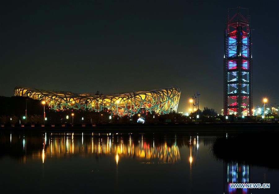 Photo taken on May 14, 2019 shows the night view of the National Stadium, also known as the Bird\'s Nest, and the Linglong Tower in Beijing, capital of China. Roads and buildings were illuminated Tuesday evening before the upcoming Conference on Dialogue of Asian Civilizations (CDAC) in Beijing. (Xinhua/Chen Jianli)