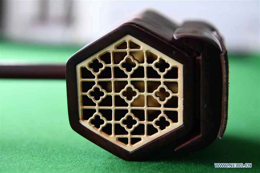 Photo taken on May 13, 2019 shows the resonator of an Erhu in Lanzhou, northwest China\'s Gansu Province. Erhu, sometimes known as the Chinese violin or Chinese two-stringed fiddle, is a Chinese traditional two-stringed bowed musical instrument. It is used as a solo instrument as well as in small ensembles and large orchestras. Erhu, traced back to ancient Chinese Tang Dynasty (618-907), is now used in both traditional and contemporary music arrangements, such as in pop, rock and jazz. The famous solo pieces include Er Quan Ying Yue (Two Springs Reflecting the Moon) by Abing and Sai Ma (Horse Race) by Huang Haihuai. (Xinhua/Fan Peishen)