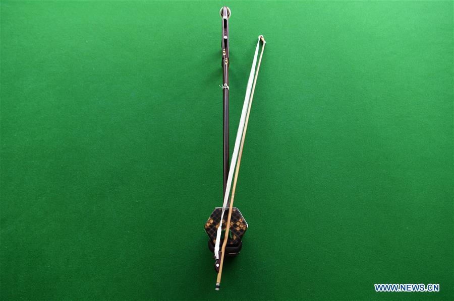 An Erhu is pictured in Lanzhou, northwest China\'s Gansu Province, May 13, 2019. Erhu, sometimes known as the Chinese violin or Chinese two-stringed fiddle, is a Chinese traditional two-stringed bowed musical instrument. It is used as a solo instrument as well as in small ensembles and large orchestras. Erhu, traced back to ancient Chinese Tang dynasty (618-907), is now used in both traditional and contemporary music arrangements, such as in pop, rock and jazz. The famous solo pieces include Er Quan Ying Yue (Two Springs Reflecting the Moon) by Abing and Sai Ma (Horse Race) by Huang Haihuai. (Xinhua/Fan Peishen)