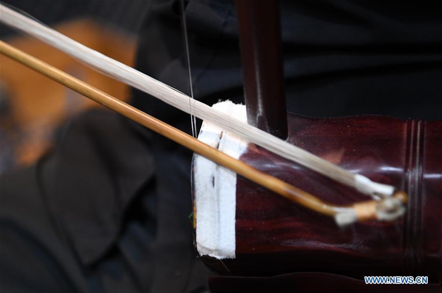 Photo taken on May 13, 2019 shows the bow and the strings of an Erhu in Lanzhou, northwest China\'s Gansu Province. Erhu, sometimes known as the Chinese violin or Chinese two-stringed fiddle, is a Chinese traditional two-stringed bowed musical instrument. It is used as a solo instrument as well as in small ensembles and large orchestras. Erhu, traced back to ancient Chinese Tang dynasty (618-907), is now used in both traditional and contemporary music arrangements, such as in pop, rock and jazz. The famous solo pieces include Er Quan Ying Yue (Two Springs Reflecting the Moon) by Abing and Sai Ma (Horse Race) by Huang Haihuai. (Xinhua/Fan Peishen)