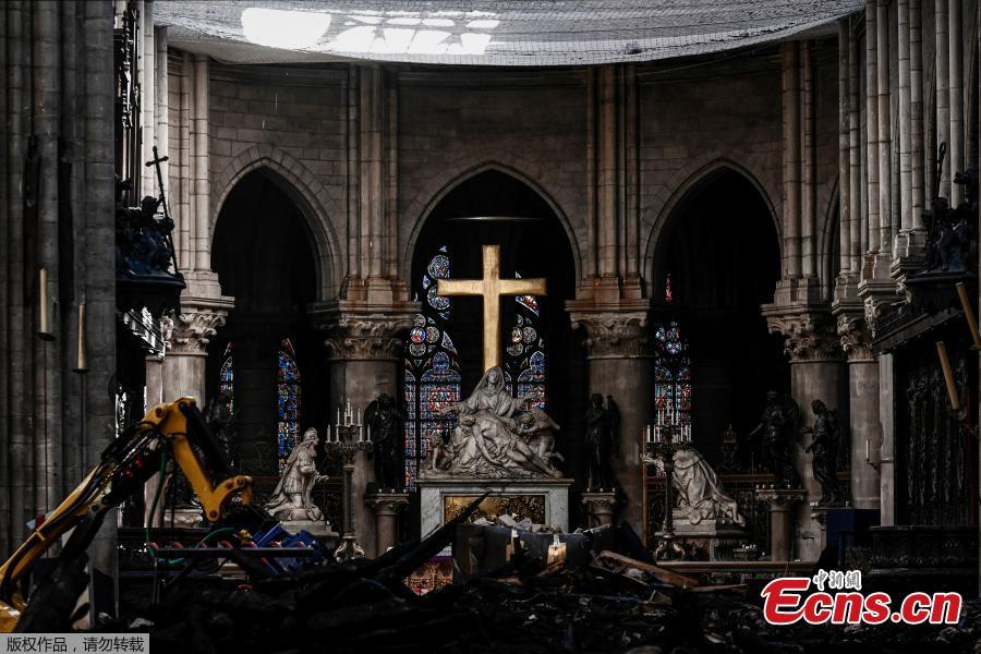 Rubble and the cross inside the Notre Dame de Paris Cathedral, Wednesday May 15, 2019 in Paris. French Culture Minister Franck Riester says that one month after a fire engulfed Notre Dame Cathedral, the edifice is still being made safe enough for restoration to begin. (Photo/Agencies)