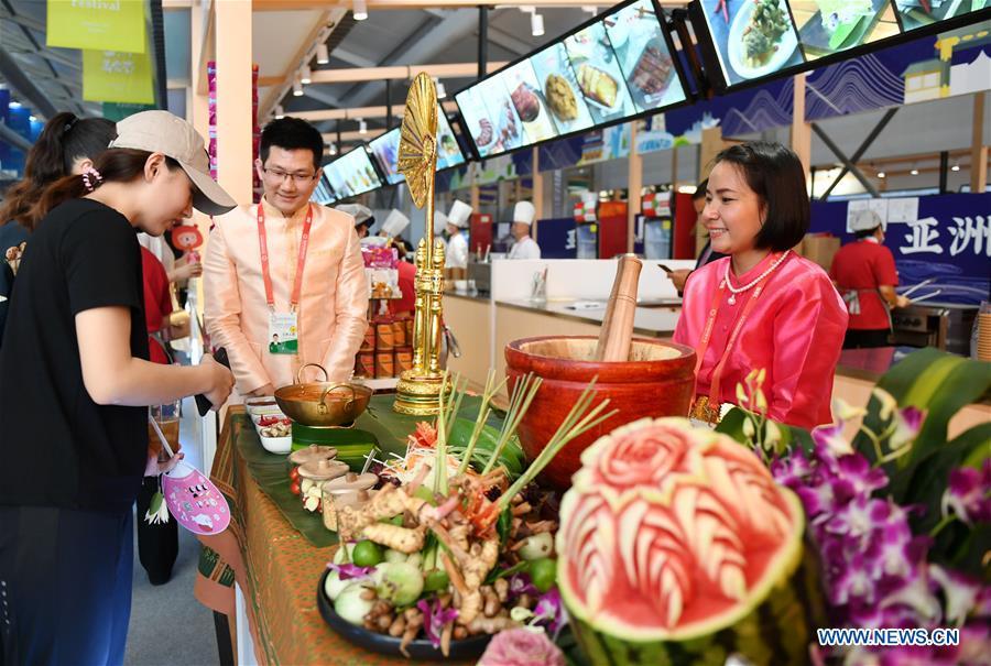Visitors view Thai food during the Asian Cuisine Festival at the Olympic Park in Beijing, capital of China, May 16, 2019. The week-long Asian Cuisine Festival, as part of the Conference on Dialogue of Asian Civilizations (CDAC), was held in four cities of Beijing, Hangzhou, Chengdu and Guangzhou. (Xinhua/Zhang Chenlin)