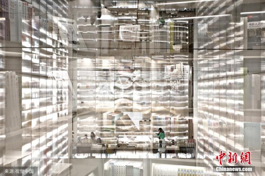 A bookstore featuring transparent bookcases in Xi’an, capital of Northwest China\'s Shaanxi province. Installed with three 12-meter-high such bookcases to show off reading materials, the bookstore offers customers an unique reading experience. (Photo/VCG)