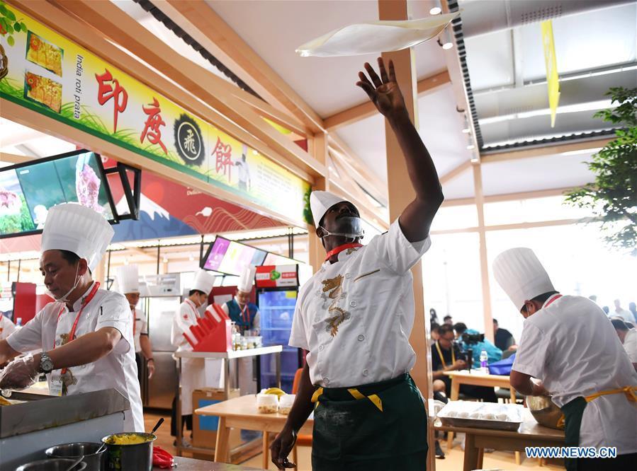 A chef makes Indian food during the Asian Cuisine Festival at the Olympic Park in Beijing, capital of China, May 16, 2019. The week-long Asian Cuisine Festival, as part of the Conference on Dialogue of Asian Civilizations (CDAC), was held in four cities of Beijing, Hangzhou, Chengdu and Guangzhou. (Xinhua/Zhang Chenlin)