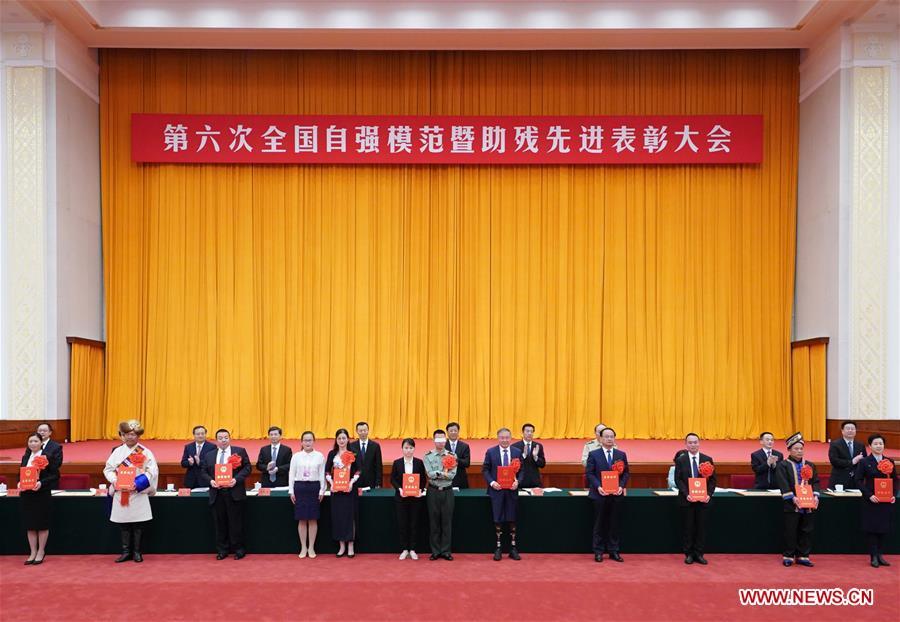 Chinese State Councilor Wang Yong attends a ceremony commending role models with disabilities and people who have made outstanding contributions in helping the disabled in Beijing, capital of China, May 16, 2019. (Xinhua/Wang Ye)