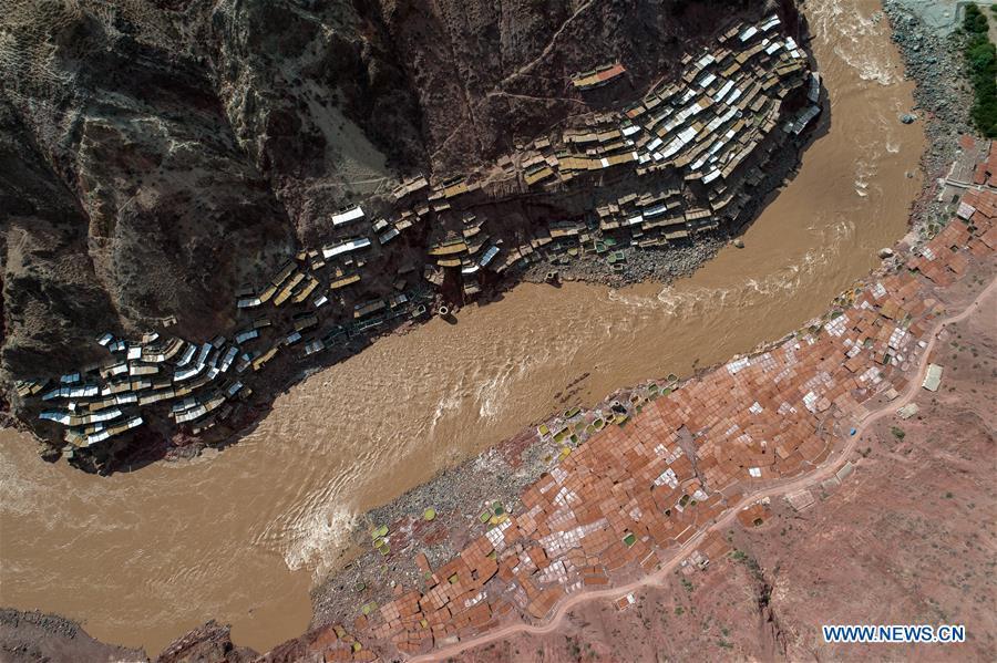 Aerial photo shows saline fields in Mangkam County, southwest China\'s Tibet Autonomous Region, May 22, 2019. An ancient technique of salt production since Tang Dynasty (618-907) is well-preserved in Mangkam County. Local people follow a salt harvesting method by collecting brines from salt mines and ponds and evaporating them in the sun until crystallization. (Xinhua/Li Xin)