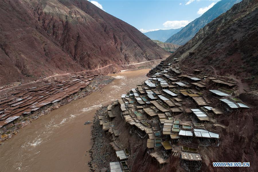 Aerial photo shows saline fields in Mangkam County, southwest China\'s Tibet Autonomous Region, May 22, 2019. An ancient technique of salt production since Tang Dynasty (618-907) is well-preserved in Mangkam County. Local people follow a salt harvesting method by collecting brines from salt mines and ponds and evaporating them in the sun until crystallization. (Xinhua/Li Xin)