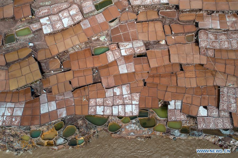 Aerial photo shows saline fields in Mangkam County, southwest China\'s Tibet Autonomous Region, May 22, 2019. An ancient technique of salt production since Tang Dynasty (618-907) is well-preserved in Mangkam County. Local people follow a salt harvesting method by collecting brines from salt mines and ponds and evaporating them in the sun until crystallization. (Xinhua/Li Xin)