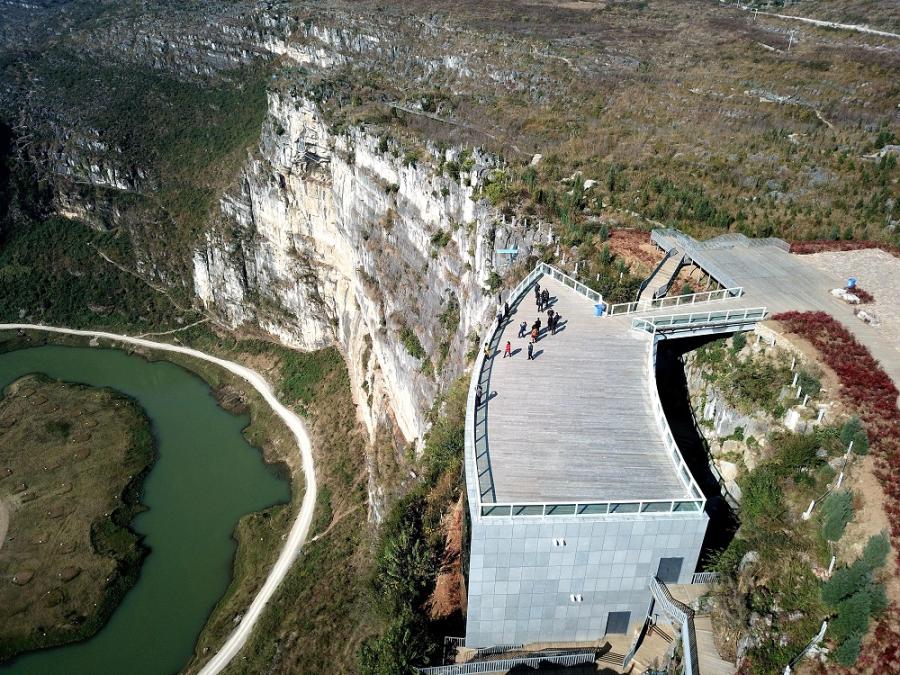 A river snakes past the Limestone Galleay perched on the side of the cliff, overlooking the incredible scenery in the valley. (Photo by Liu Chaofu/for chinadaily.com.cn)