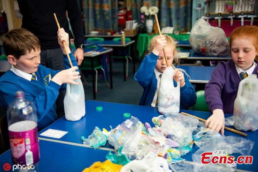 Kids at St Mary\'s RC Primary School enjoy a lesson in their recently built eco classroom made out of plastic bottles filled with plastic waste, also known as \'eco bricks\' in Lancashire, UK. These schoolkids have built their own CLASSROOM out of 3,000 plastic bottles. Pupils at St Mary’s RC Primary School in Accrington, Lancashire, turned two tonnes of recycled plastic into ‘eco bricks’ to build the environmentally friendly area. (Photo/IC)