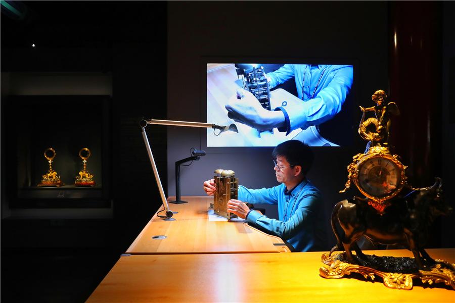 Wang Jin, an antique clock restorer, demonstrates his craftsmanship to visitors at the exhibition. (Photo provided to China Daily)

The Palace Museum is generally believed to hold one of the world\'s best collections of mechanical clocks from the 17th and 18th centuries, thanks to the wealth of the Qing Dynasty (1644-1911) emperors and their habit of ordering the latest timepieces from Europe.

\