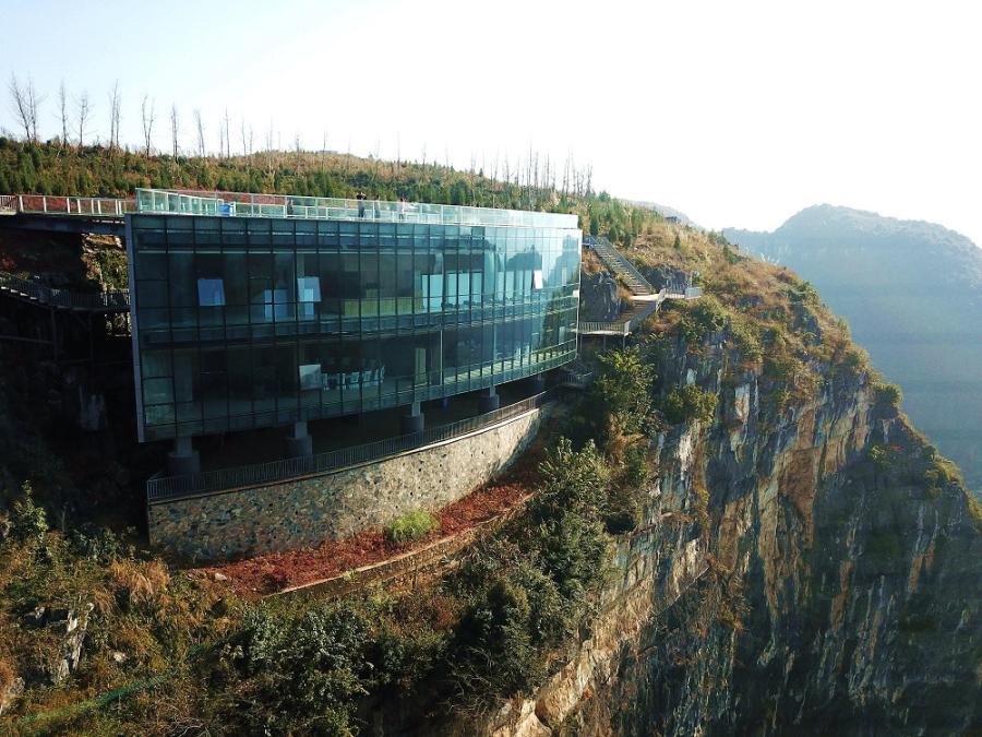 Sunlight hits part of the Limestone Galleay, the sheer cliff it is built on and the terraced landscaping around it.  (Photo by Liu Chaofu/for chinadaily.com.cn)