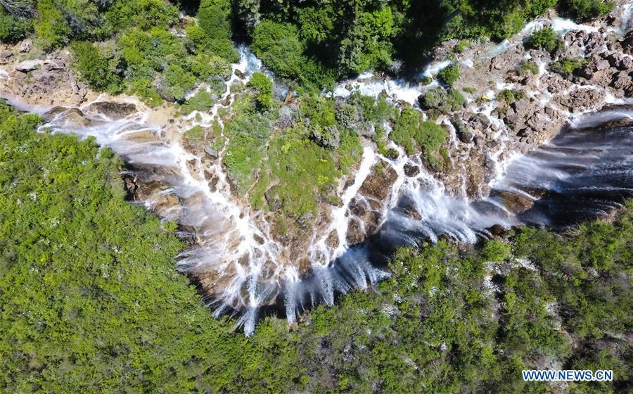 Aerial photo shows the scenery of the Nuorilang Waterfall in the Jiuzhaigou National Park in southwest China\'s Sichuan Province, June 5, 2019. Due to damages caused by the magnitude-7.0 earthquake that hit here on Aug. 8, 2017, the park has been temporarily closed since July 2018 for renovation. (Xinhua/Xue Yubin)