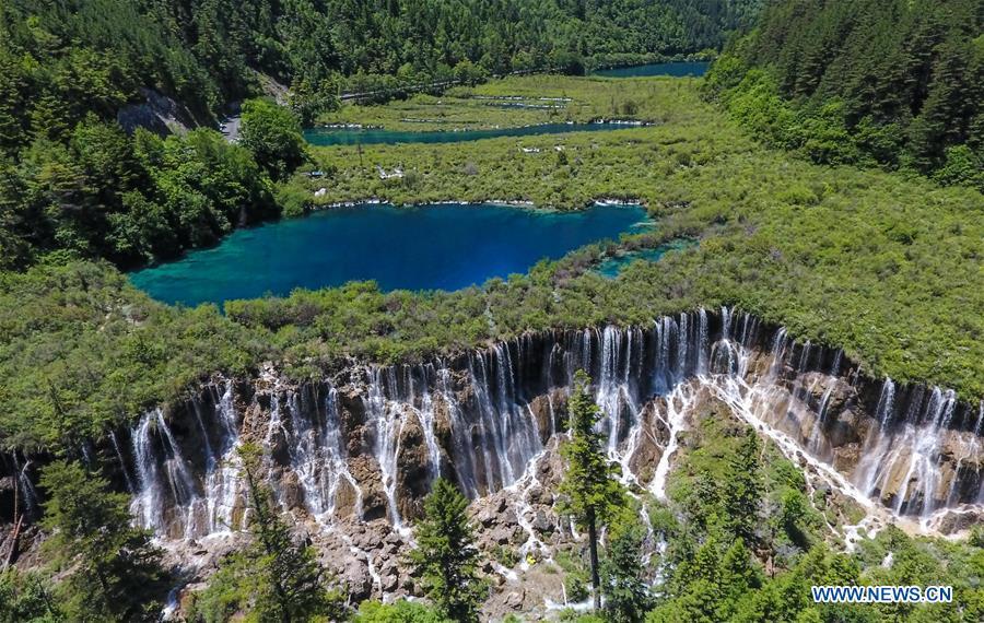 Aerial photo shows the scenery of the Nuorilang Waterfall in the Jiuzhaigou National Park in southwest China\'s Sichuan Province, June 5, 2019. Due to damages caused by the magnitude-7.0 earthquake that hit here on Aug. 8, 2017, the park has been temporarily closed since July 2018 for renovation. (Xinhua/Xue Yubin)