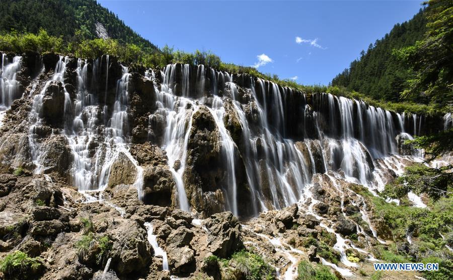 Photo shows the scenery of the Nuorilang Waterfall in the Jiuzhaigou National Park in southwest China\'s Sichuan Province, June 5, 2019. Due to damages caused by the magnitude-7.0 earthquake that hit here on Aug. 8, 2017, the park has been temporarily closed since July 2018 for renovation. (Xinhua/Meng Dingbo)