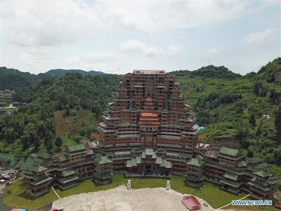 Aerial photo taken on June 7, 2019 shows a wooden building of Shui ethnic group in Yingshan Town of Dushan County, southwest China\'s Guizhou Province. The 24-story, 99.9-meter-high traditional Shui-style wooden building in Dushan is of \