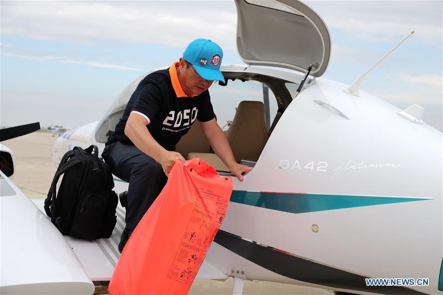 Zhang Bo unloads an immersion suit from his plane at an airport in Chicago, the United States, on June 9, 2019. After flying 68 days and making 50 stops, 57-year-old Bo Zhang completed his second around-the-world flight and landed in Chicago on Sunday morning. On April 2, Zhang kicked off the flight in the same airport in Chicago. In 68 days, he flied through 21 countries in three continents and over three oceans, with total mileage reaching 41,000 kilometers. (Xinhua/Wang Ping)