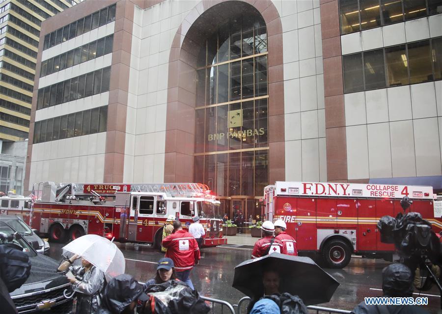 Rescuers and police officers work near the building where a helicopter crashed in Manhattan, New York, the United States, June 10, 2019. One person was killed after a helicopter crashed onto the roof of a skyscraper in Midtown Manhattan of New York City Monday afternoon, according to media reports. (Xinhua/Wang Ying)