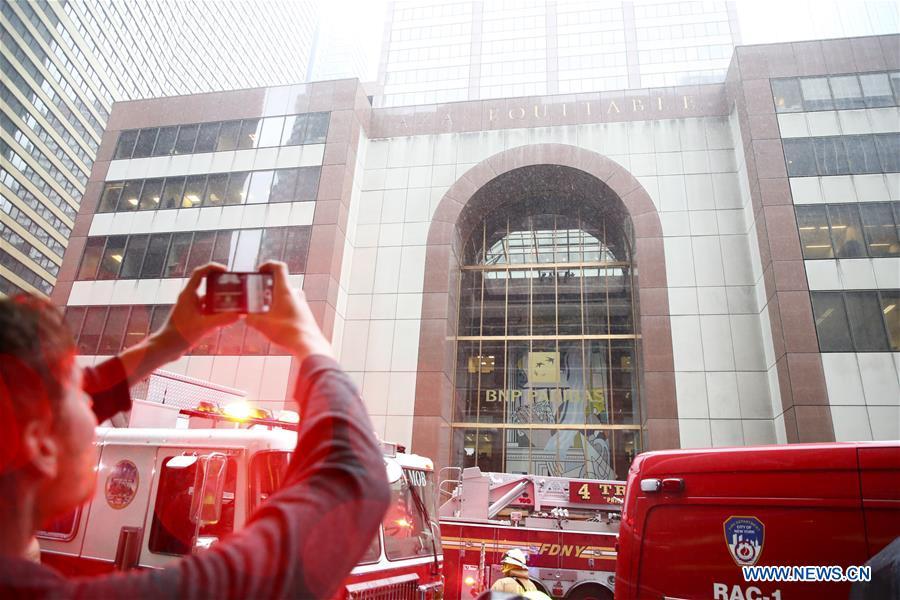 A journalist takes video of the building where a helicopter crashed in Manhattan, New York, the United States, June 10, 2019. One person was killed after a helicopter crashed onto the roof of a skyscraper in Midtown Manhattan of New York City Monday afternoon, according to media reports. (Xinhua/Wang Ying)