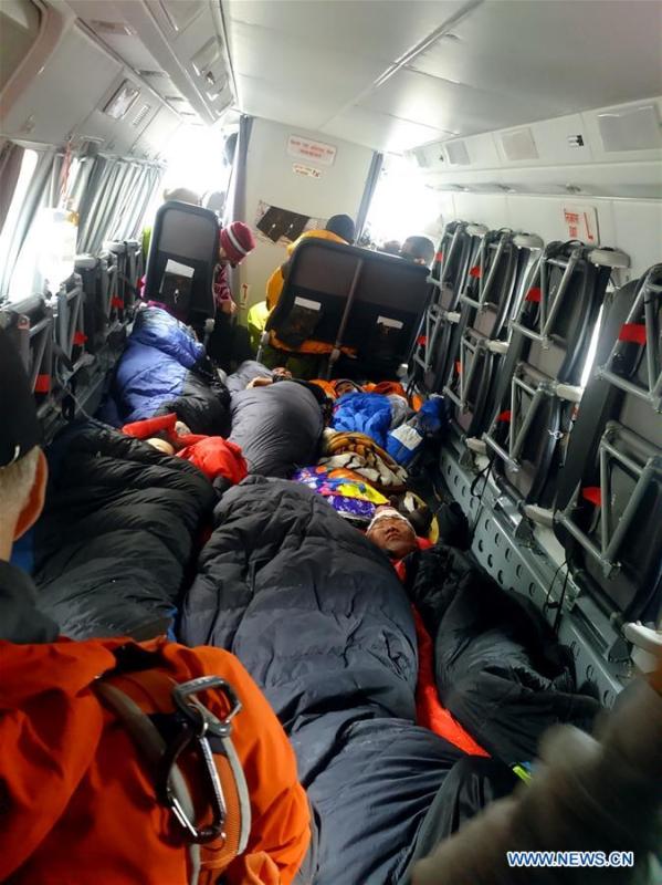 Climbers injured during the avalanche in Mount Qomolangma rest on a rescue plane, April 26, 2015. (Xinhua/Li Liang)