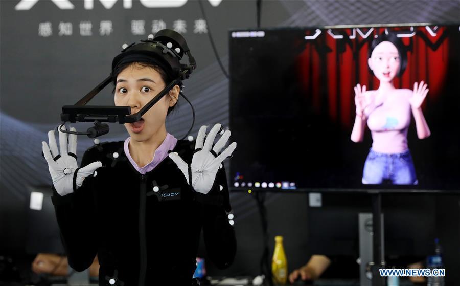 A staff member demonstrates a gesture capturing system during the 2019 Consumer Electronics Show (CES) Asia in east China\'s Shanghai, June 11, 2019. The 2019 Consumer Electronics Show (CES) Asia kicked off on Tuesday in Shanghai. The three-day exhibition showcased the latest achievements in 5G technology, artificial intelligence, augmented/virtual reality and vehicle technology. (Xinhua/Fang Zhe)