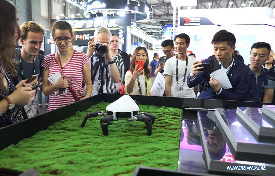 Visitors view a spider-like programmable robot with six legs during the 2019 Consumer Electronics Show (CES) Asia in east China\'s Shanghai, June 11, 2019. The 2019 Consumer Electronics Show (CES) Asia kicked off on Tuesday in Shanghai. The three-day exhibition showcased the latest achievements in 5G technology, artificial intelligence, augmented/virtual reality and vehicle technology. (Xinhua/Fang Zhe)