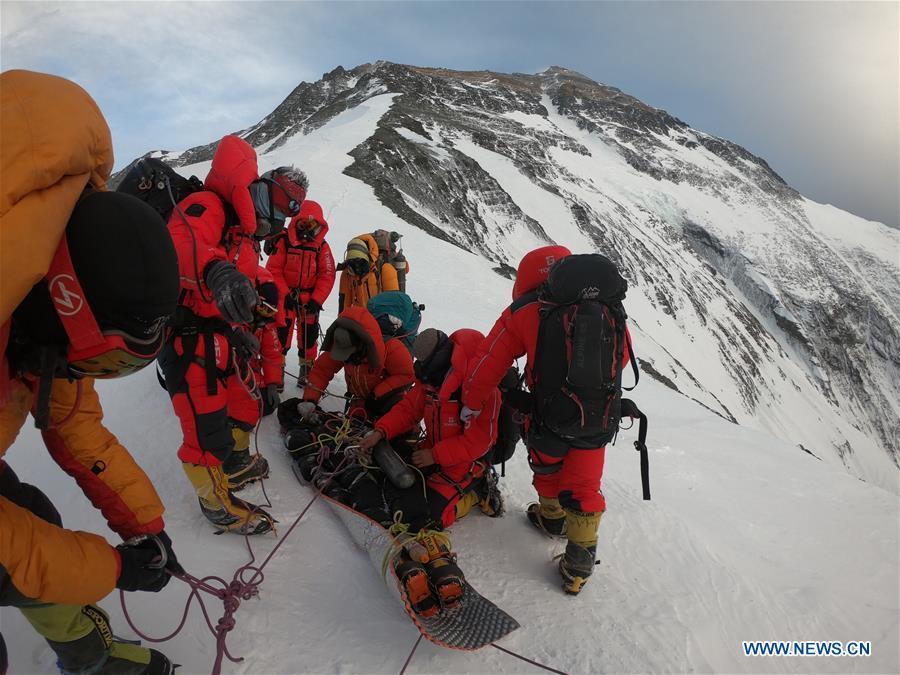 Chinese rescuers prepare to carry an Australian climber downhill at the north slope of the Mount Qomolangma, May 22, 2019. (Xinhua)

This climbing season for Mt. Qomolangma, or Mount Everest, has hit the headlines around the world for becoming the deadliest since 2015 with at least 11 people losing their lives.

The growing fatalities indicate the need for stricter regulations.
