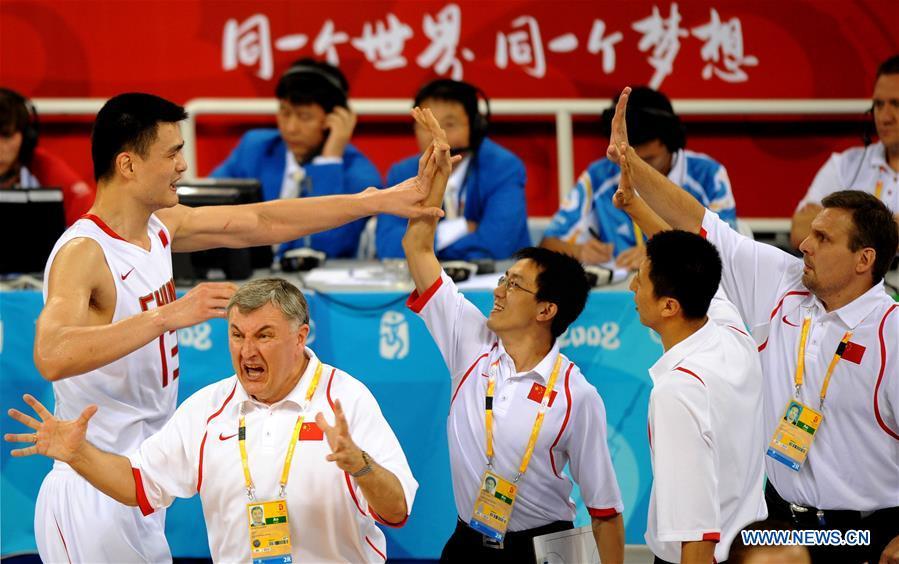 Yao Ming (L) of China celebrates with teammates after defeating Germany in a group match to be qualified for the quarterfinals at the Olympic Games in Beijing, capital of China, Aug. 16, 2008. This year marks the 70th anniversary of the founding of the People\'s Republic of China (PRC). On April 5, 1959, Rong Guotuan won the champion of the men\'s singles event at the 25th ITTF World Table Tennis Championships in Dortmund, Germany, becoming China\'s first ever world champion. Chinese players have made more achievements during the 60 years since then. (Xinhua/Li Gang)