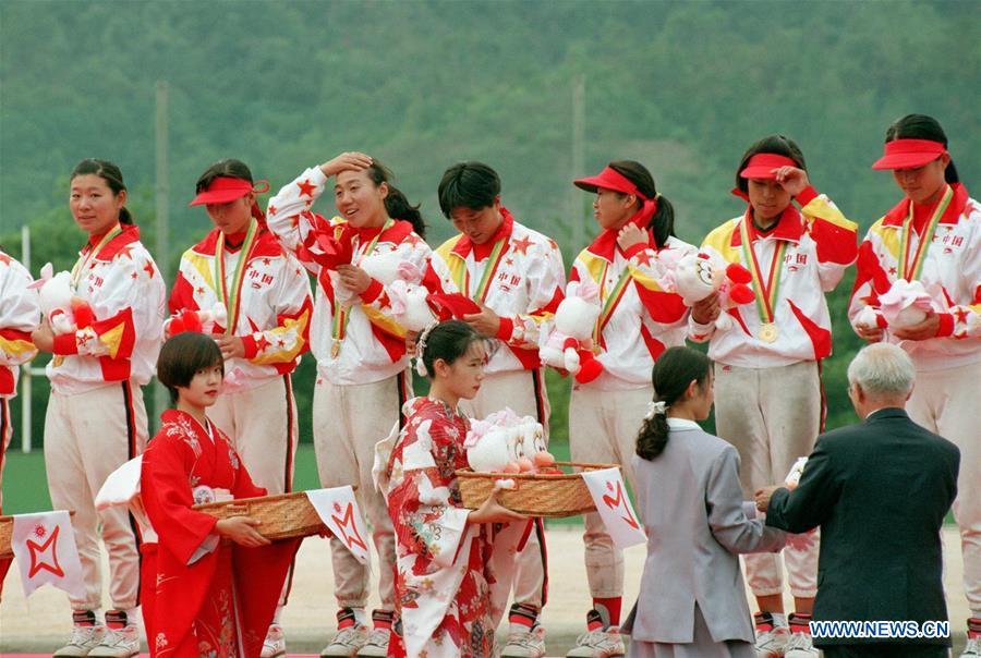 Members of the women\'s softball team of China attend the awarding ceremony after winning the gold at the Asian Games in Hiroshima, Japan, Oct. 7, 1994. This year marks the 70th anniversary of the founding of the People\'s Republic of China (PRC). On April 5, 1959, Rong Guotuan won the champion of the men\'s singles event at the 25th ITTF World Table Tennis Championships in Dortmund, Germany, becoming China\'s first ever world champion. Chinese players have made more achievements during the 60 years since then. (Xinhua/Guan Tianyi)