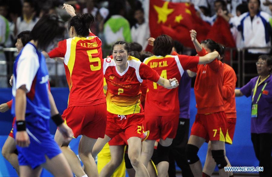 Members of the women\'s handball team of China celebrate victory after the final with Japan at the Asian Games in Guangzhou, capital of south China\'s Guangdong Province, Nov. 26, 2010. This year marks the 70th anniversary of the founding of the People\'s Republic of China (PRC). On April 5, 1959, Rong Guotuan won the champion of the men\'s singles event at the 25th ITTF World Table Tennis Championships in Dortmund, Germany, becoming China\'s first ever world champion. Chinese players have made more achievements during the 60 years since then. (Xinhua/Lu Hanxin)