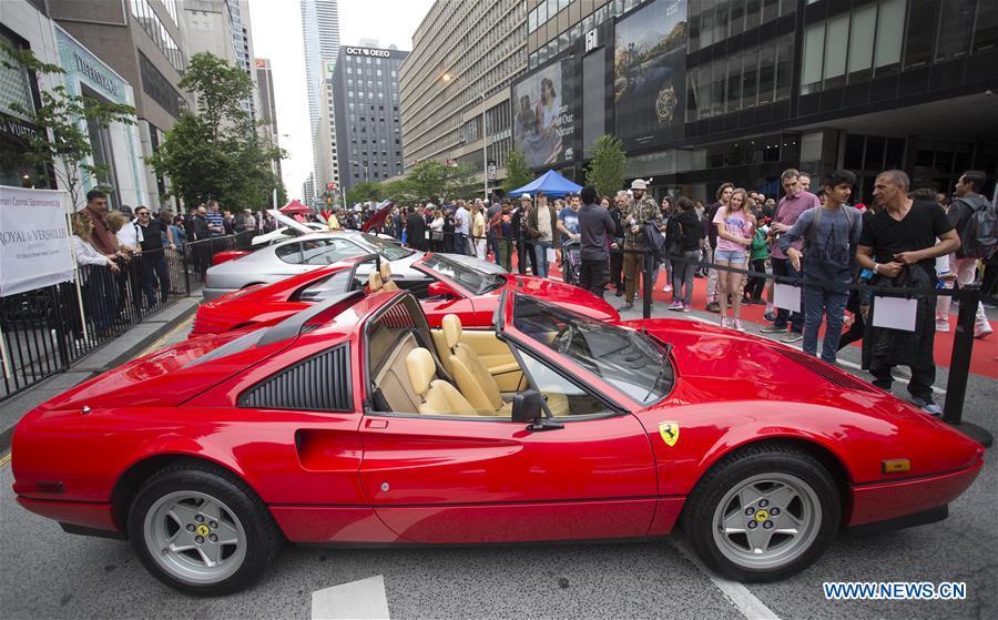 People visit the 2019 Yorkville Exotic Car Show in Toronto, Canada, June 16, 2019. More than 110 classic and exotic cars were displayed at the annual Father\'s Day event on Sunday, attracting tens of thousands of visitors. (Xinhua/Zou Zheng)